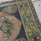Close-up of the navy blue Turkish small vintage rug showing traditional details, hand-knotted weave, wool and cotton and low pile.