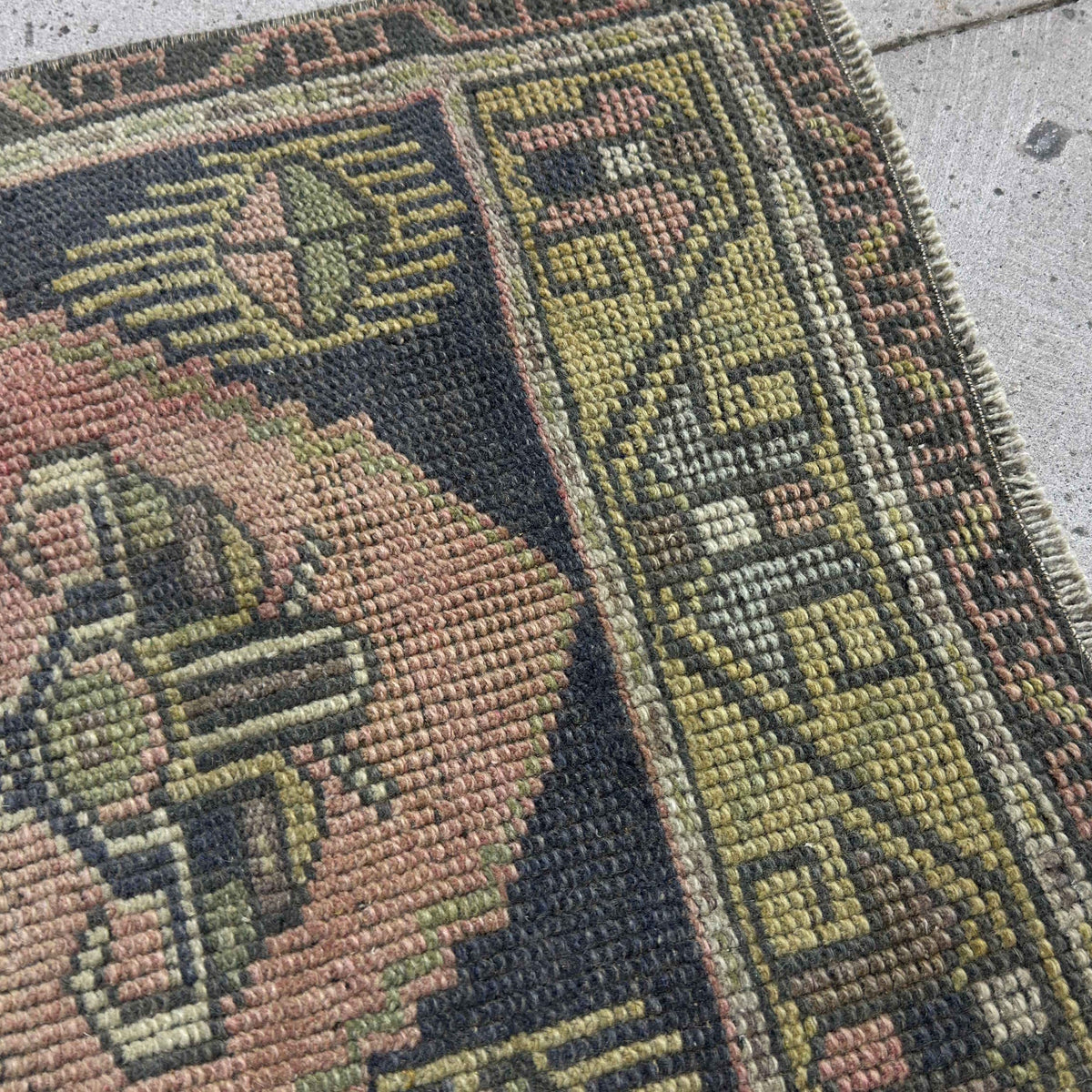 Close-up of the navy blue Turkish small vintage rug showing traditional details, hand-knotted weave, wool and cotton and low pile.