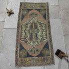 Navy blue 2' x 3' Turkish small vintage rug in wool and cotton, shown on the floor.