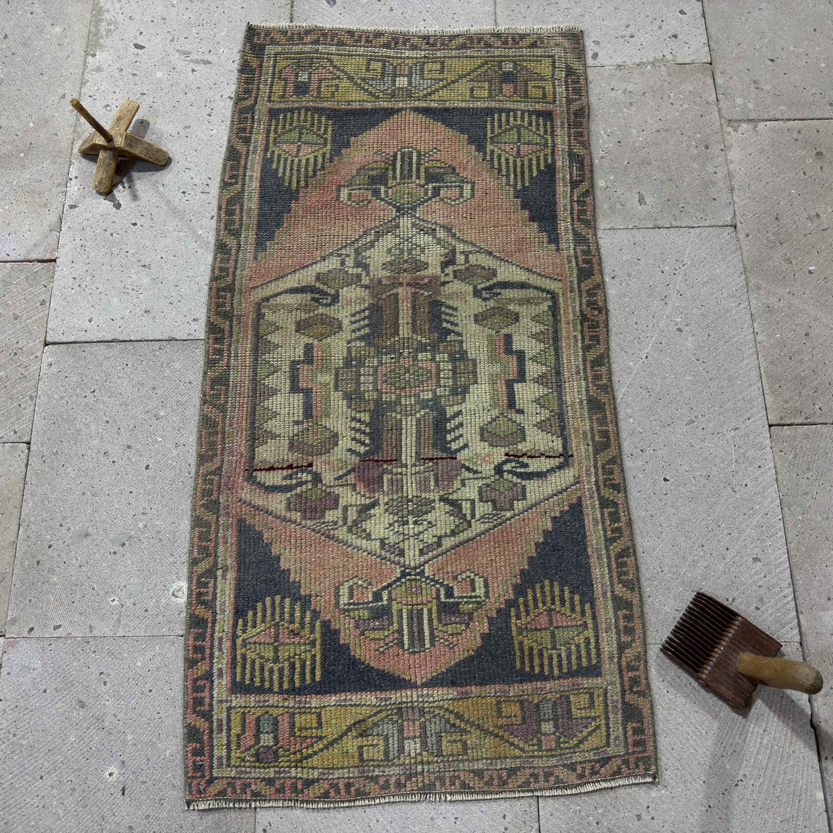 Navy blue 2' x 3' Turkish small vintage rug in wool and cotton, shown on the floor.