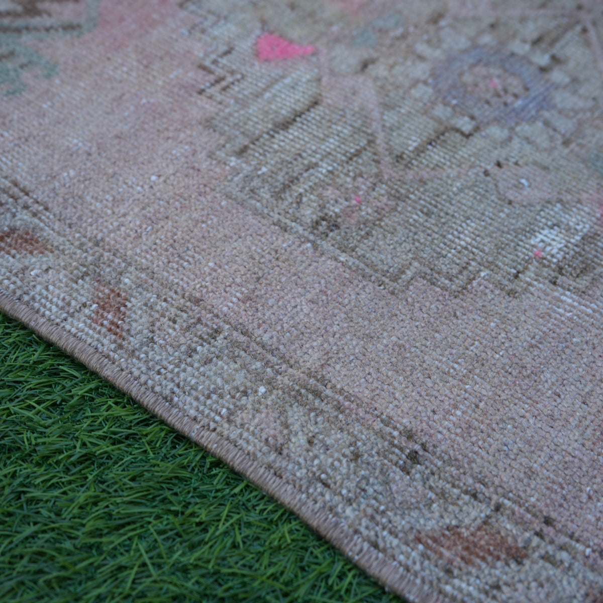 Pink 2' x 3' Turkish small vintage rug in wool and cotton, shown on the floor.