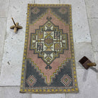 Pink 2' x 3' Turkish small vintage rug in wool and cotton, shown on the floor.