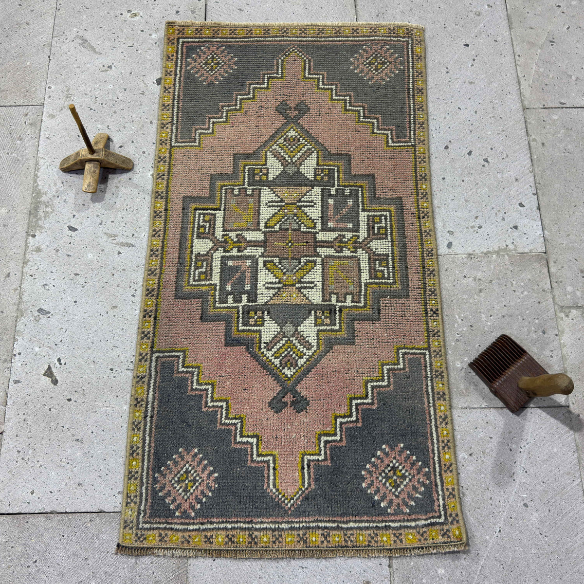 Pink 2' x 3' Turkish small vintage rug in wool and cotton, shown on the floor.