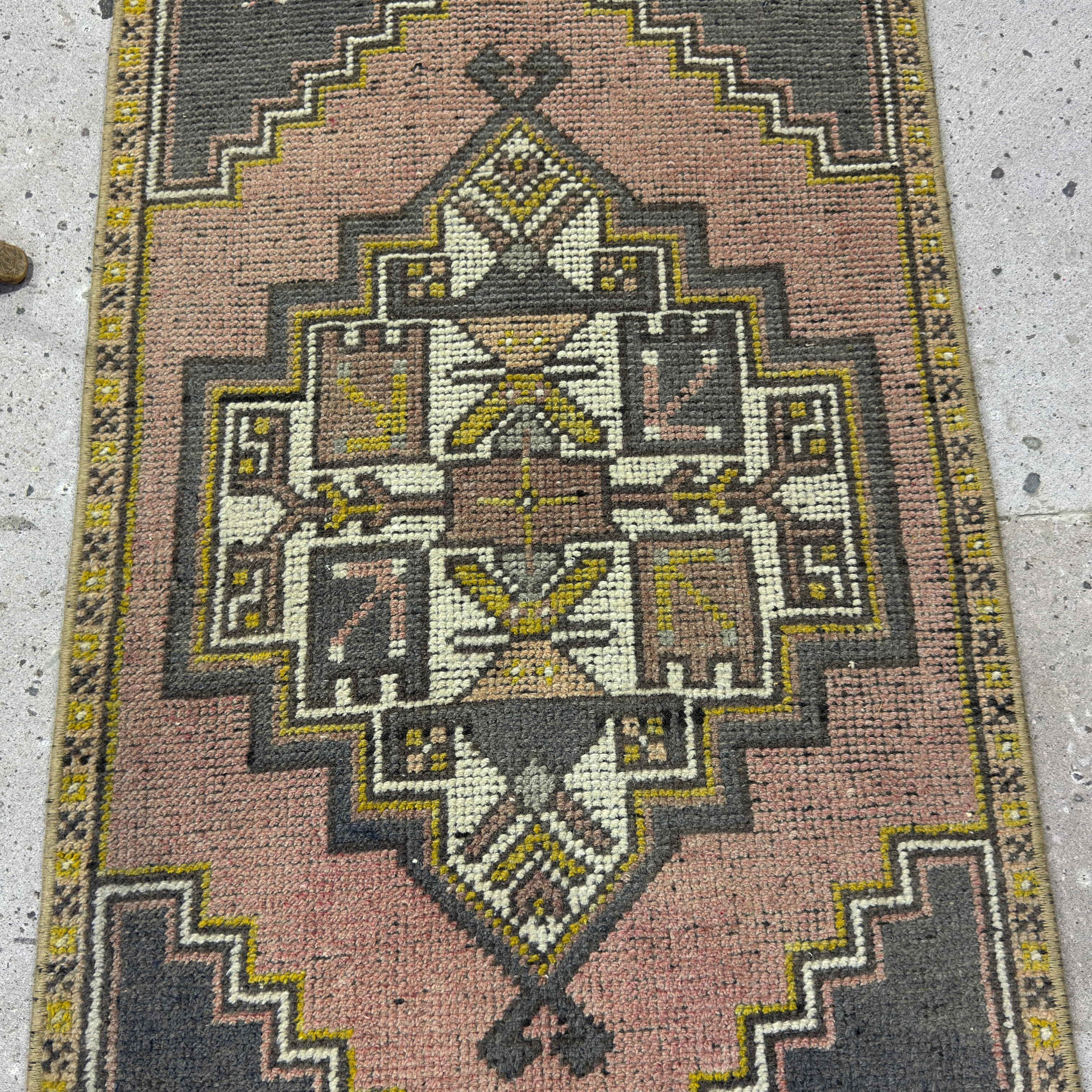 1970s pink Turkish small vintage rug with traditional design, hand-knotted weave and low pile.