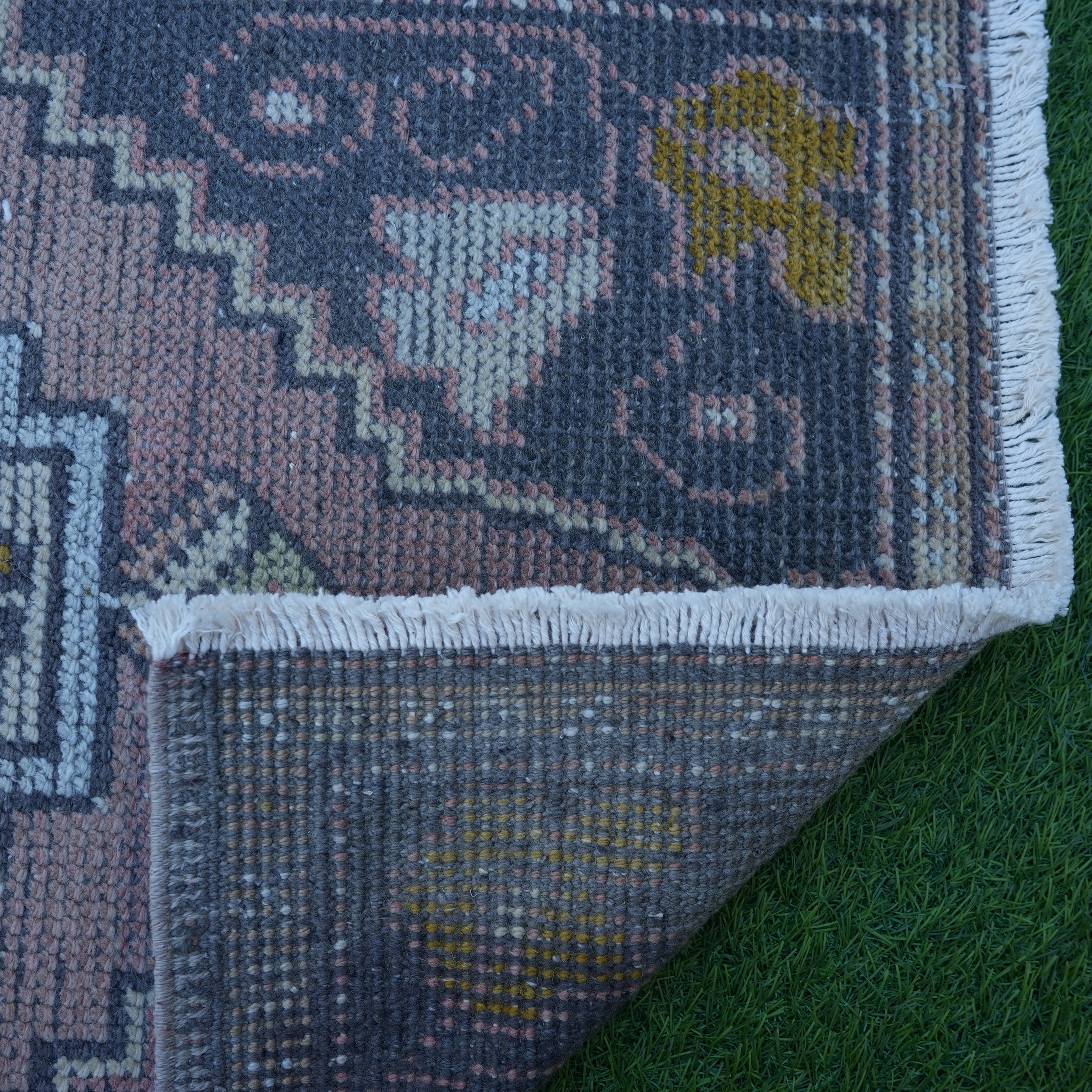 1970s pink Turkish small vintage rug with traditional design, hand-knotted weave and low pile.