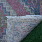 1970s red Turkish small vintage rug with traditional design, hand-knotted weave and low pile.
