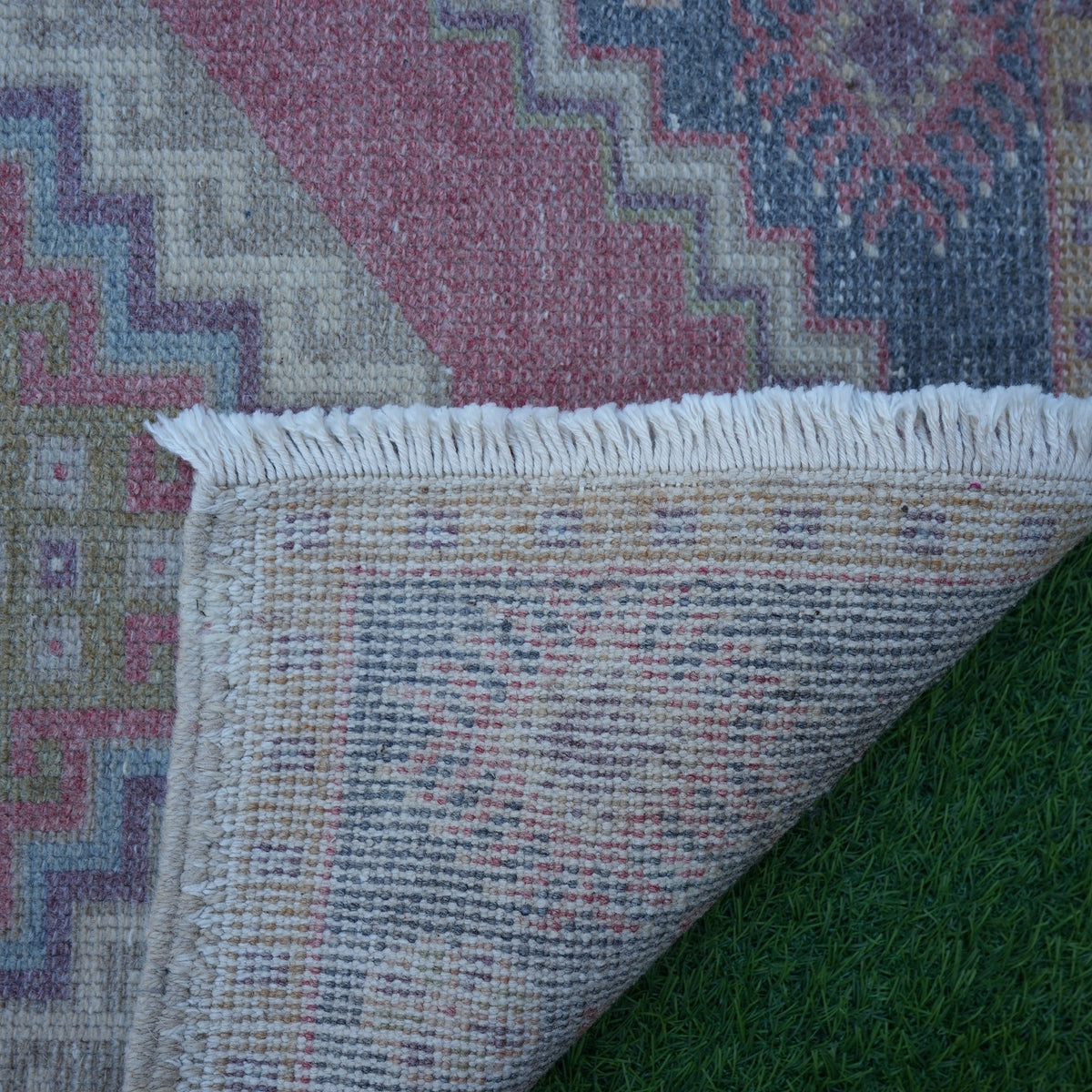 1970s red Turkish small vintage rug with traditional design, hand-knotted weave and low pile.