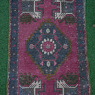 Close-up of the red Turkish small vintage rug showing traditional details, hand-knotted weave, wool and cotton and low pile.