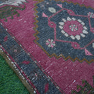 Red 2' x 3' Turkish small vintage rug in wool and cotton, shown on the floor.