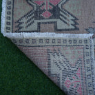 1970s red Turkish small vintage rug with traditional design, hand-knotted weave and low pile.