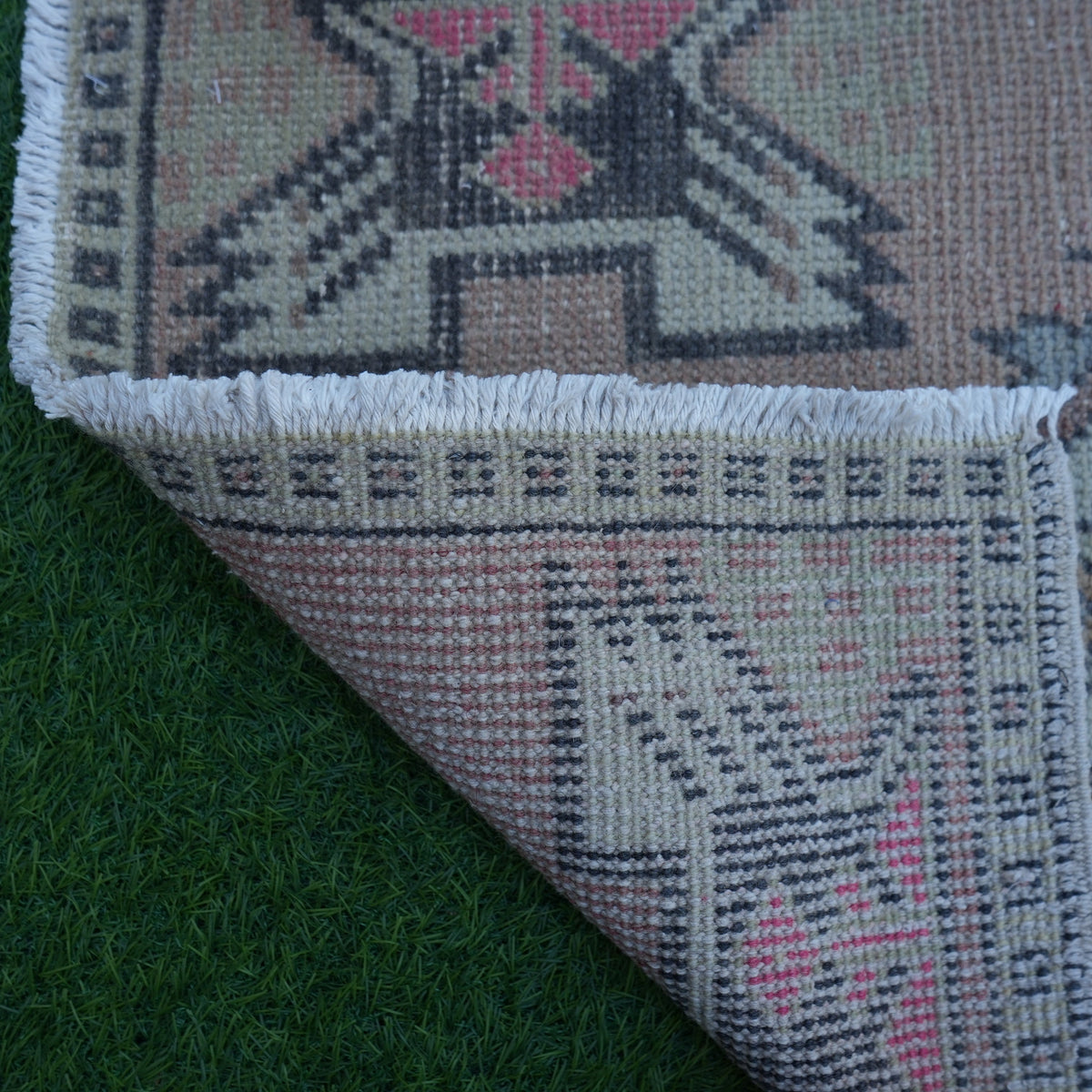 1970s red Turkish small vintage rug with traditional design, hand-knotted weave and low pile.