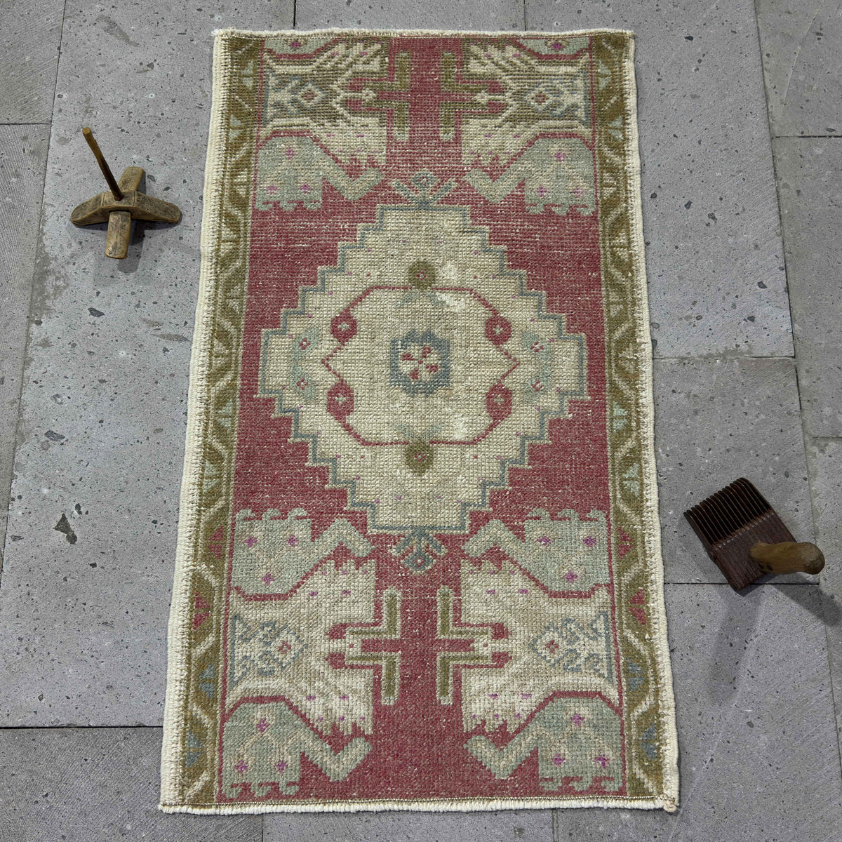 Red 2' x 3' Turkish small vintage rug in wool and cotton, shown on the floor.