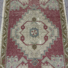 1970s red Turkish small vintage rug with traditional design, hand-knotted weave and low pile.