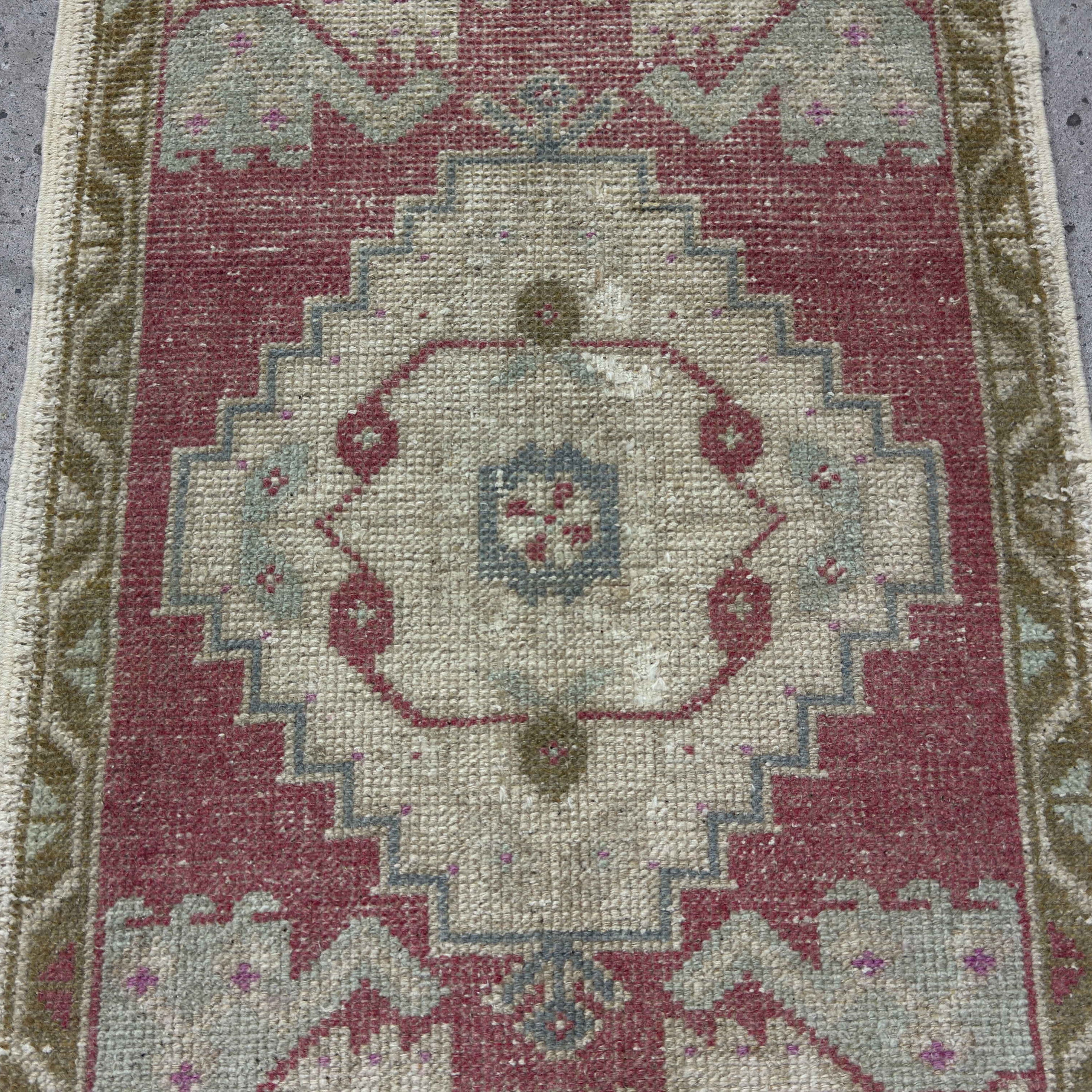 1970s red Turkish small vintage rug with traditional design, hand-knotted weave and low pile.