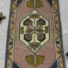 1970s pink Turkish small vintage rug with traditional design, hand-knotted weave and low pile.