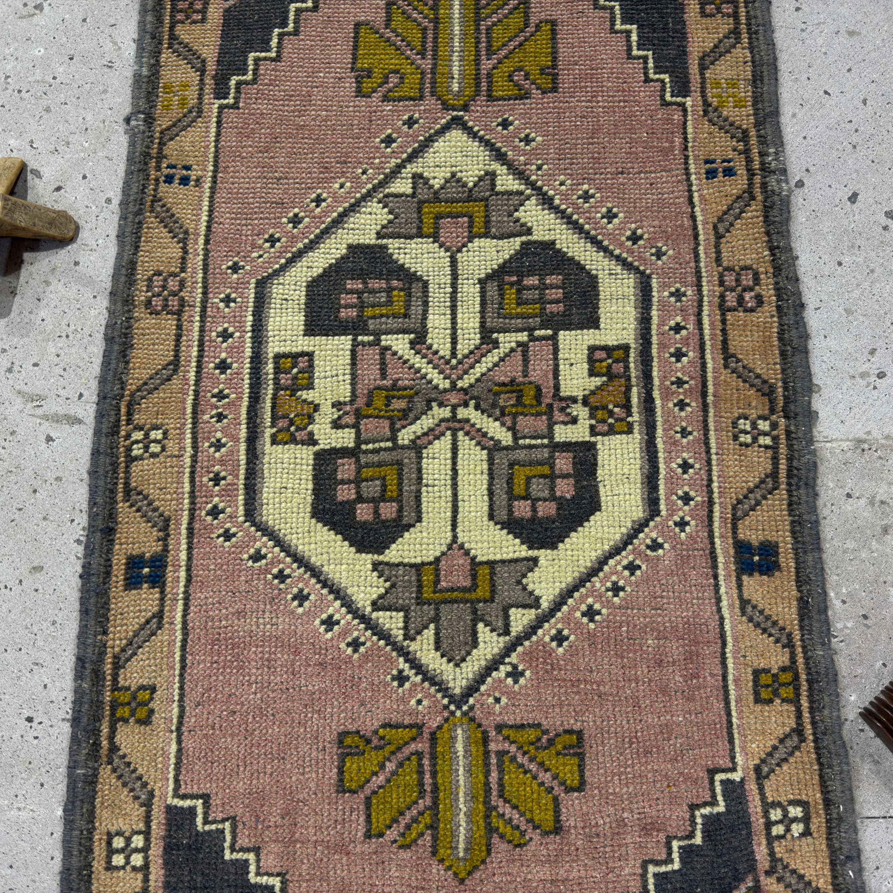 1970s pink Turkish small vintage rug with traditional design, hand-knotted weave and low pile.