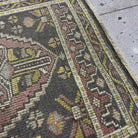 Close-up of the pink Turkish small vintage rug showing traditional details, hand-knotted weave, wool and cotton and low pile.