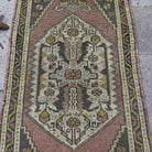 1970s pink Turkish small vintage rug with traditional design, hand-knotted weave and low pile.