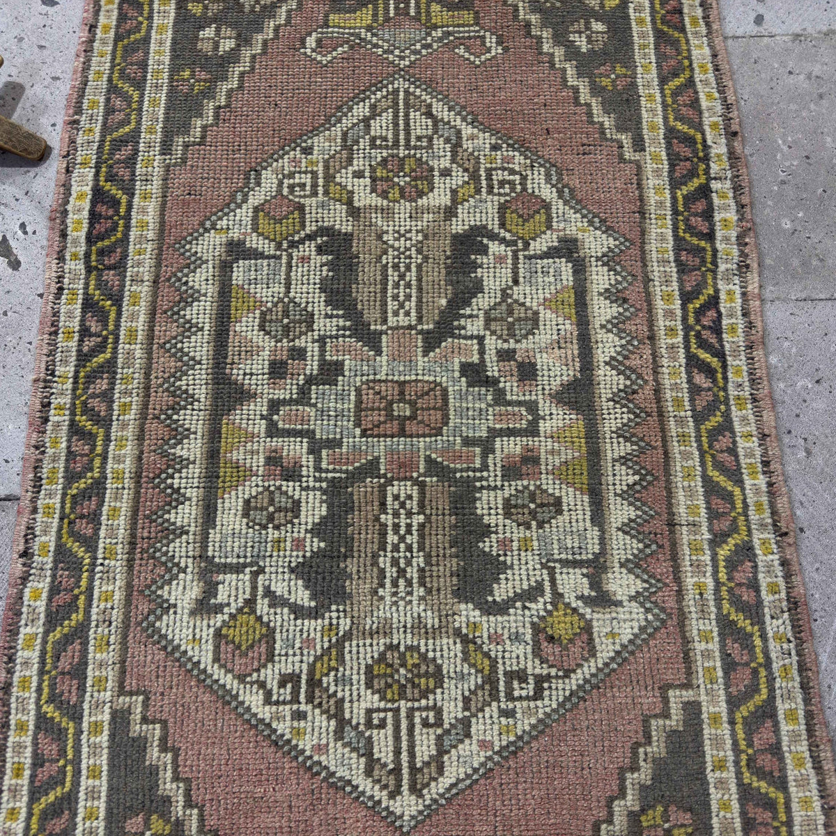 1970s pink Turkish small vintage rug with traditional design, hand-knotted weave and low pile.