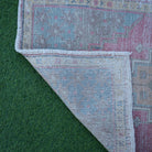 1970s pink Turkish small vintage rug with traditional design, hand-knotted weave and low pile.