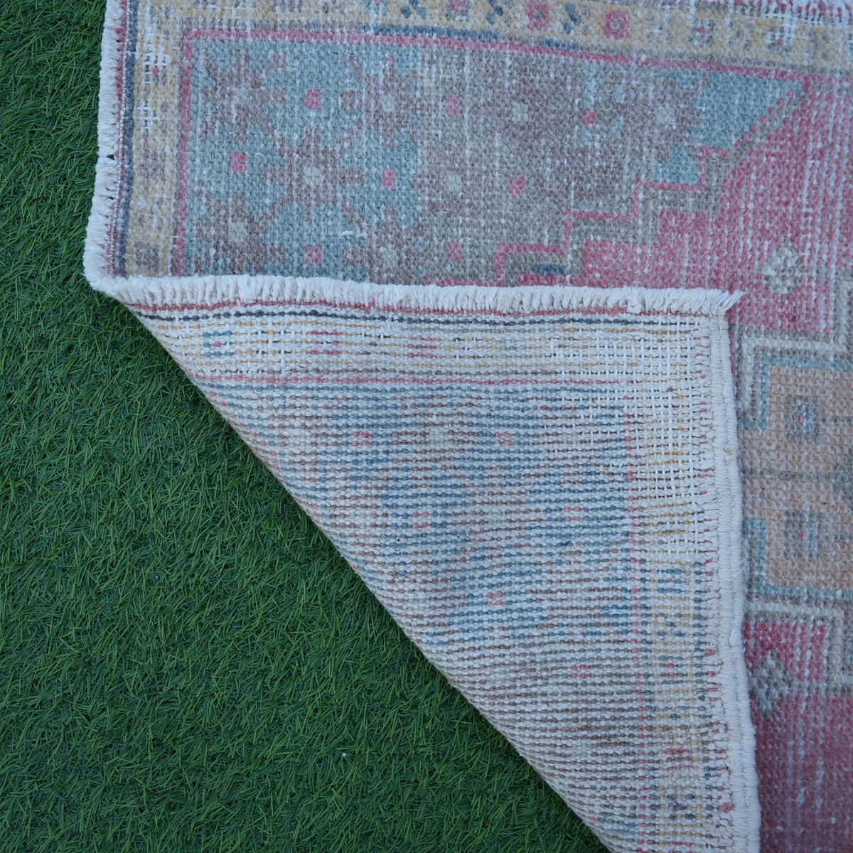 1970s pink Turkish small vintage rug with traditional design, hand-knotted weave and low pile.