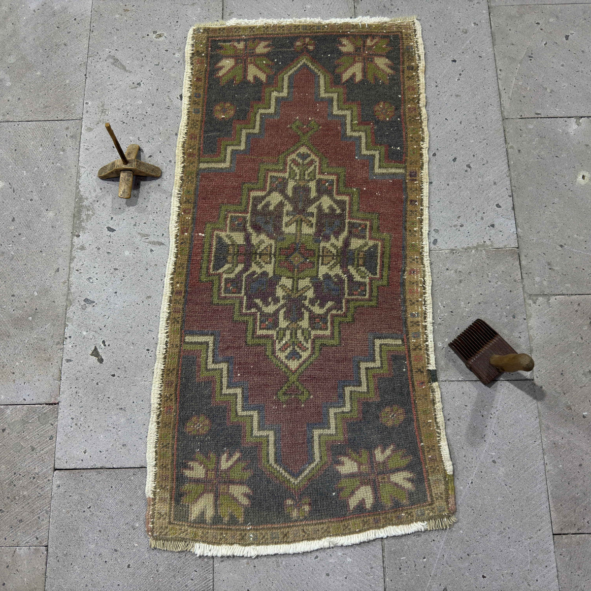 Red 2' x 4' Turkish small vintage rug in wool and cotton, shown on the floor.