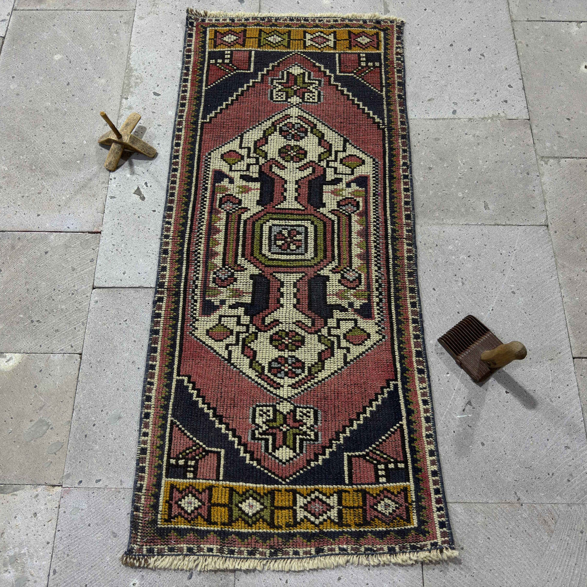 Red 2' x 4' Turkish small vintage rug in wool and cotton, shown on the floor.