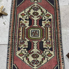 1970s red Turkish small vintage rug with traditional design, hand-knotted weave and low pile.