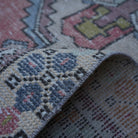 Additional view of the pale red Turkish small vintage rug, hand-knotted in wool and cotton.
