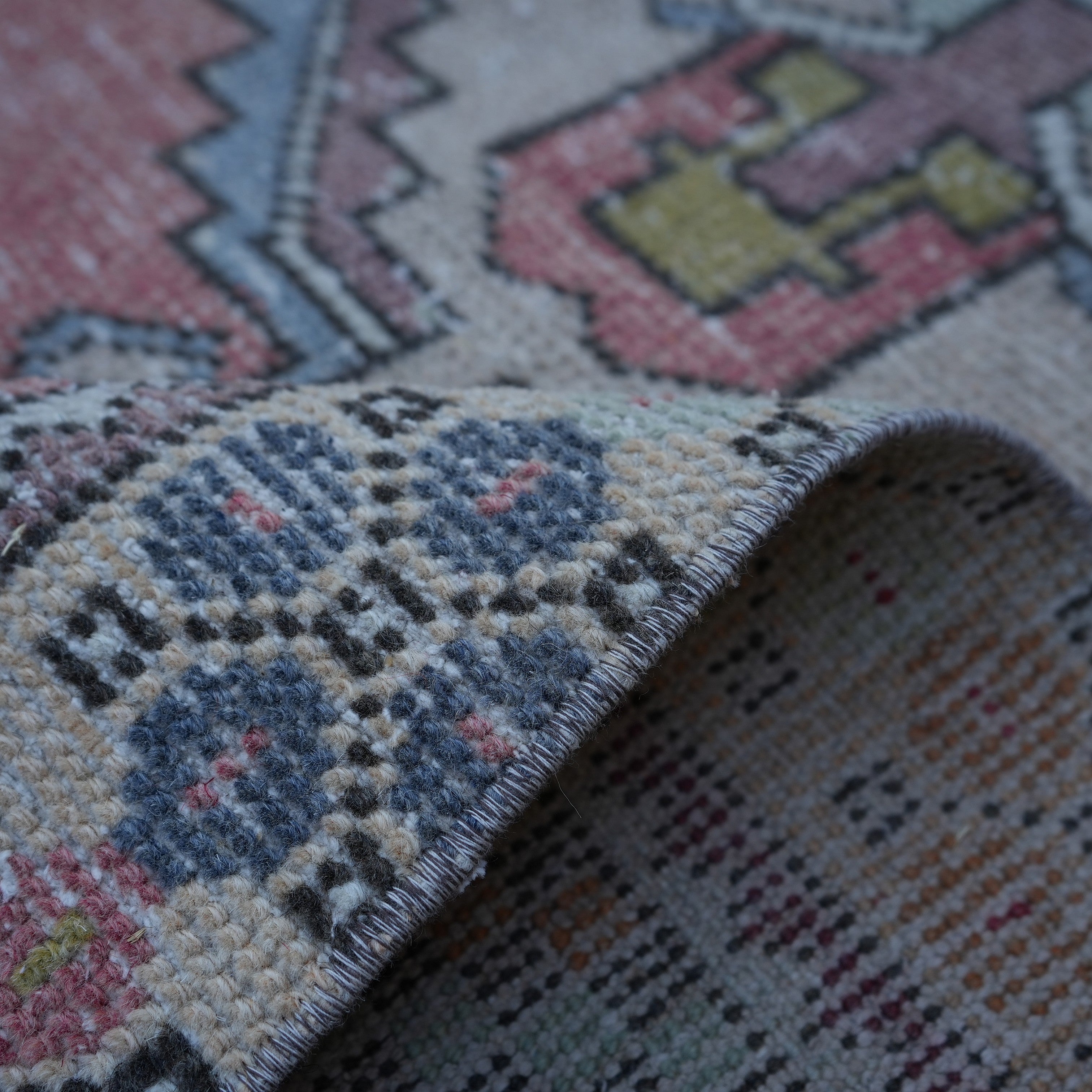 Additional view of the pale red Turkish small vintage rug, hand-knotted in wool and cotton.