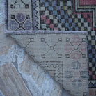 1970s red Turkish small vintage rug with traditional design, hand-knotted weave and low pile.