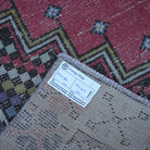 Red 3' x 6' Turkish small vintage rug from the 1970s with traditional design.
