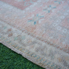 Pale Orange 2' x 4' Turkish small wool rug in wool, shown on the floor.