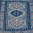 Close-up of the red Turkish square vintage rug, hand-knotted weave, wool and low pile.