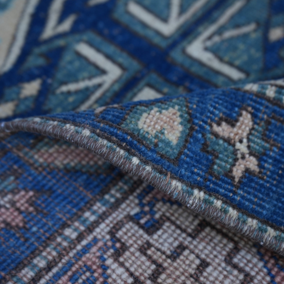 Additional view of the red Turkish square vintage rug, hand-knotted in wool.