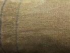 Beige Turkish throw pillow, shown on the floor.