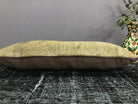 Beige Turkish throw pillow, shown on the floor.