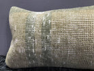Close-up of the beige Turkish throw pillow showing neutral details, low pile.