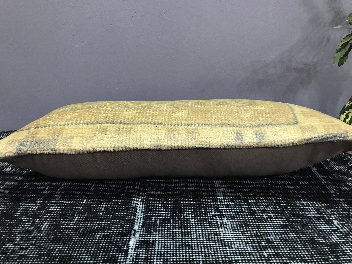 Beige Turkish throw pillow, shown on the floor.