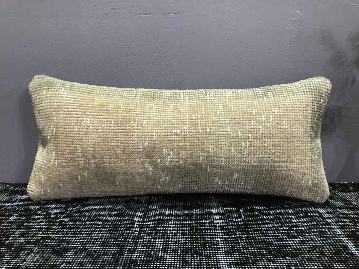 Close-up of the beige Turkish throw pillow showing neutral details, low pile.