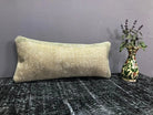 Beige Turkish throw pillow, shown on the floor.