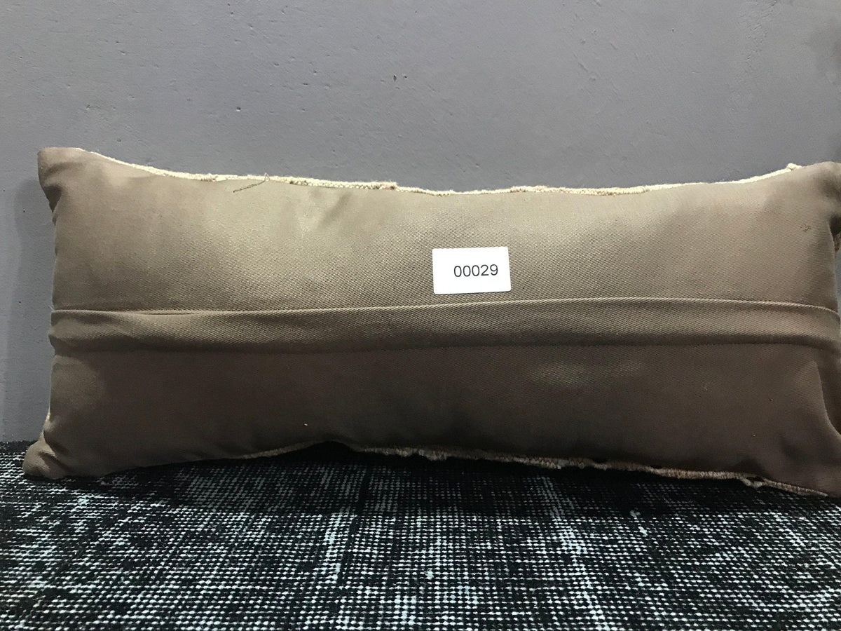 Beige Turkish throw pillow, shown on the floor.