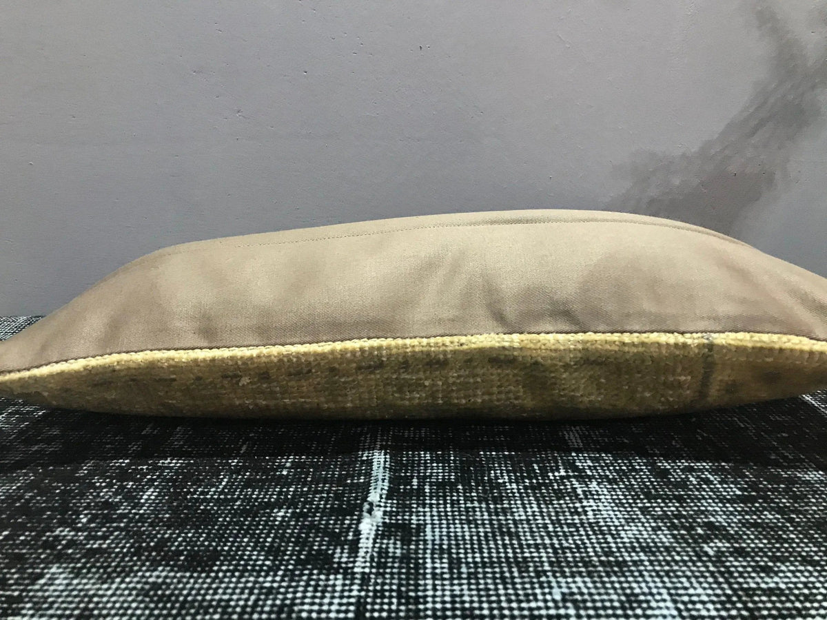 Beige Turkish throw pillow, shown on the floor.