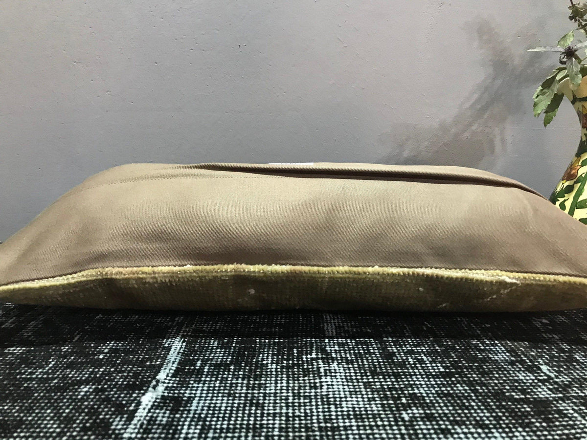 Beige Turkish throw pillow, shown on the floor.