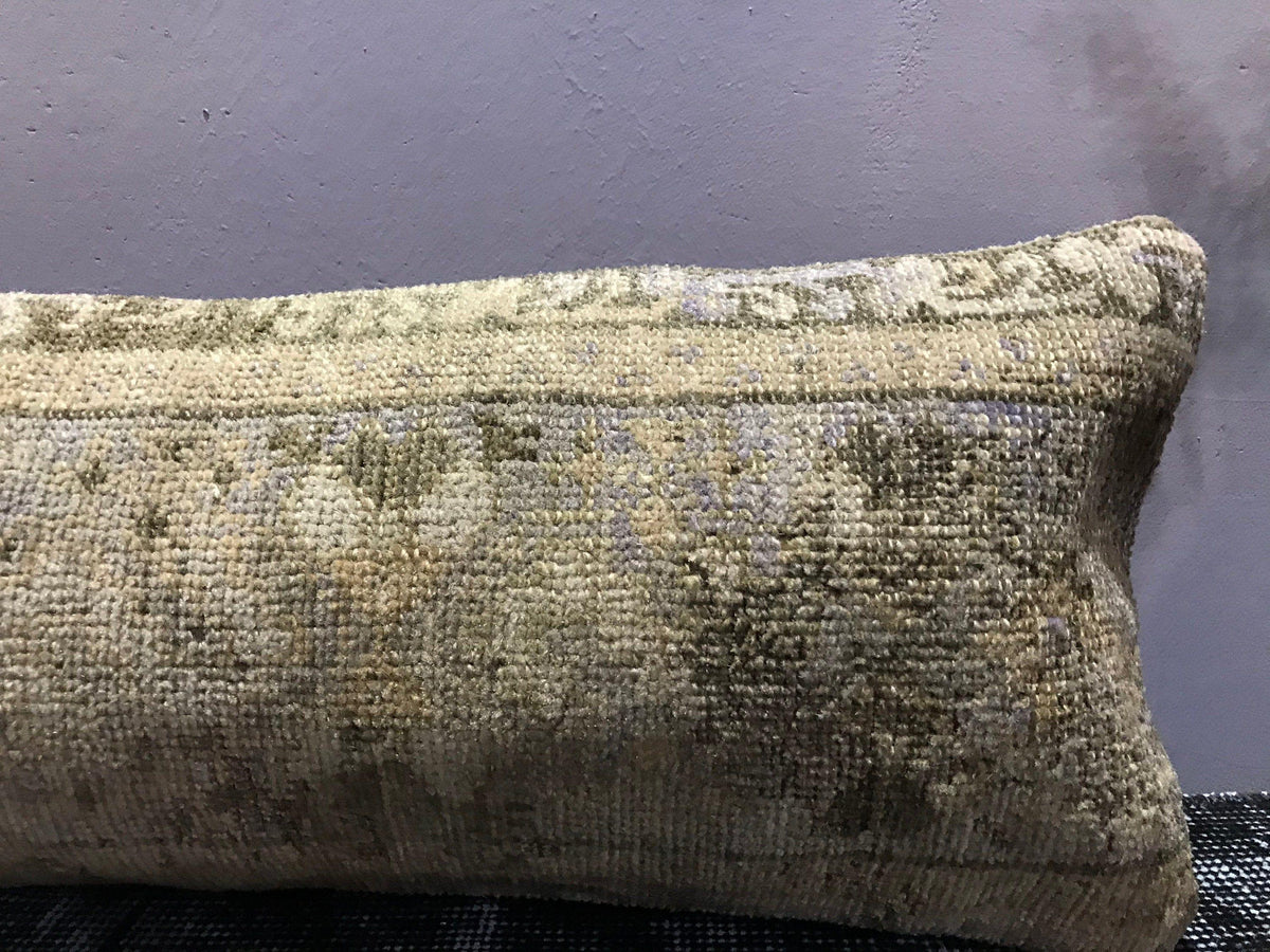 Close-up of the beige Turkish throw pillow showing traditional details, low pile.