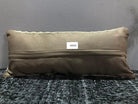 Beige Turkish throw pillow, shown on the floor.