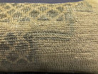 Close-up of the beige Turkish throw pillow showing neutral details, low pile.
