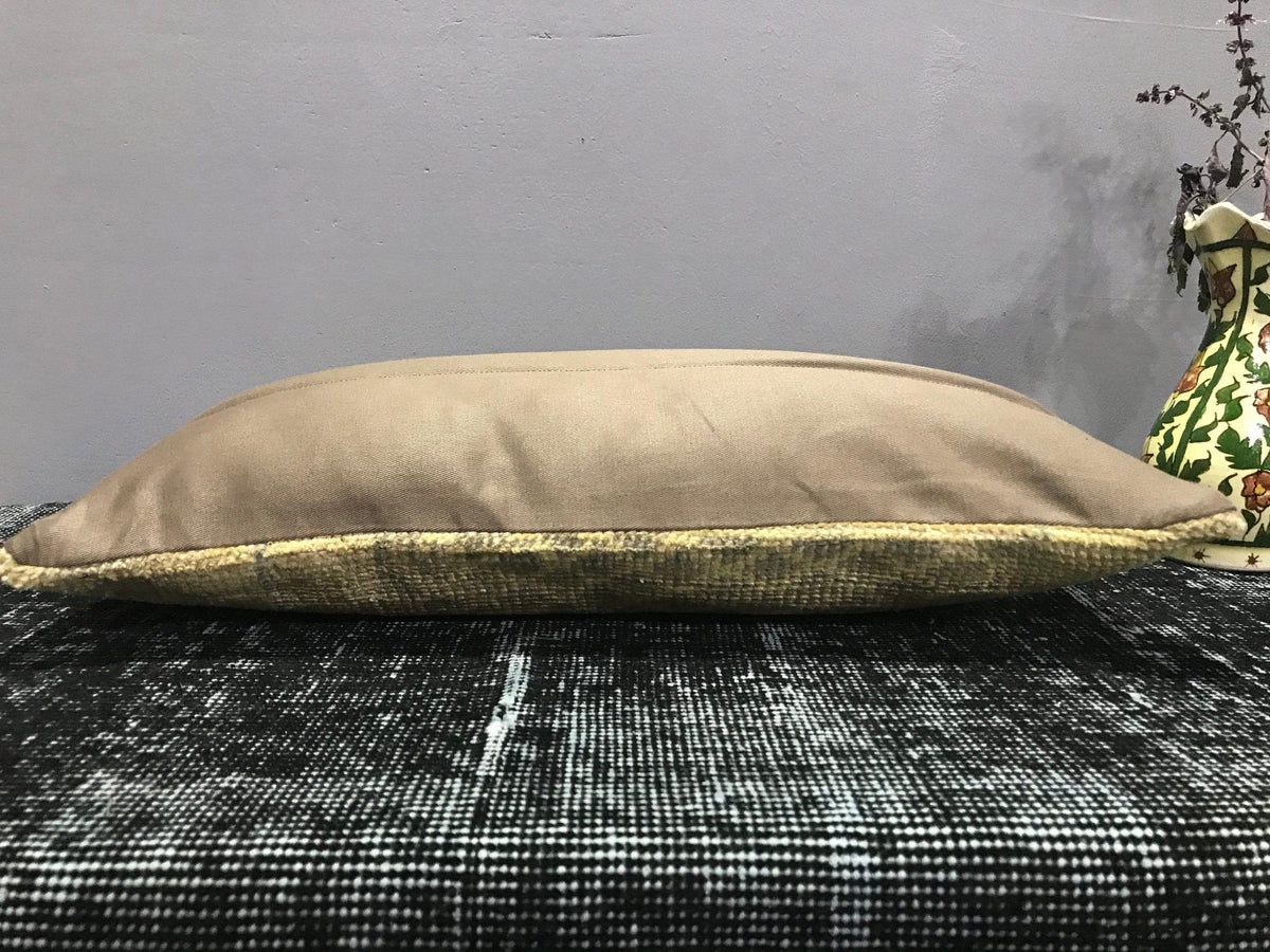 Beige Turkish throw pillow, shown on the floor.
