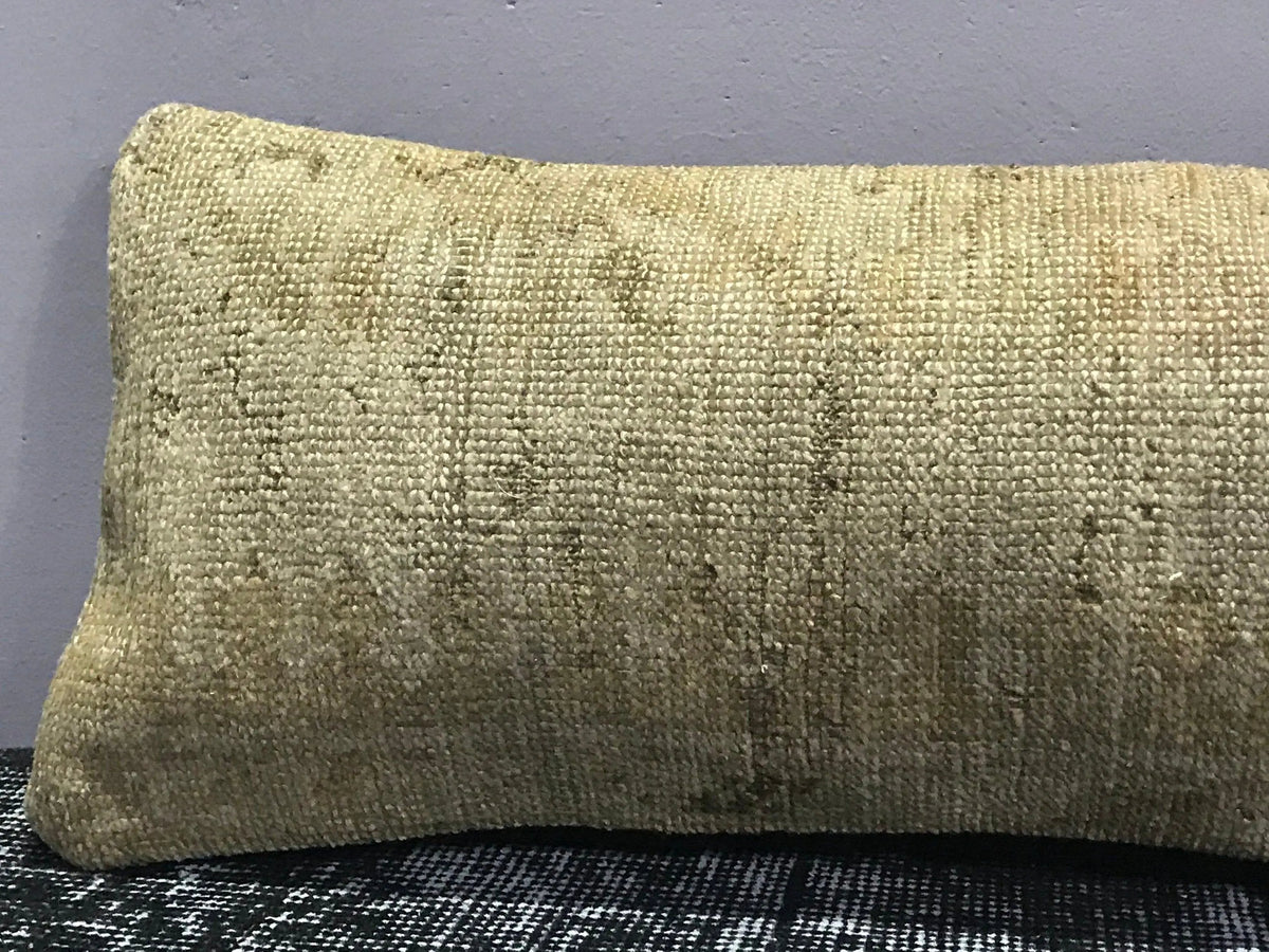 Close-up of the beige Turkish throw pillow showing neutral details, low pile.