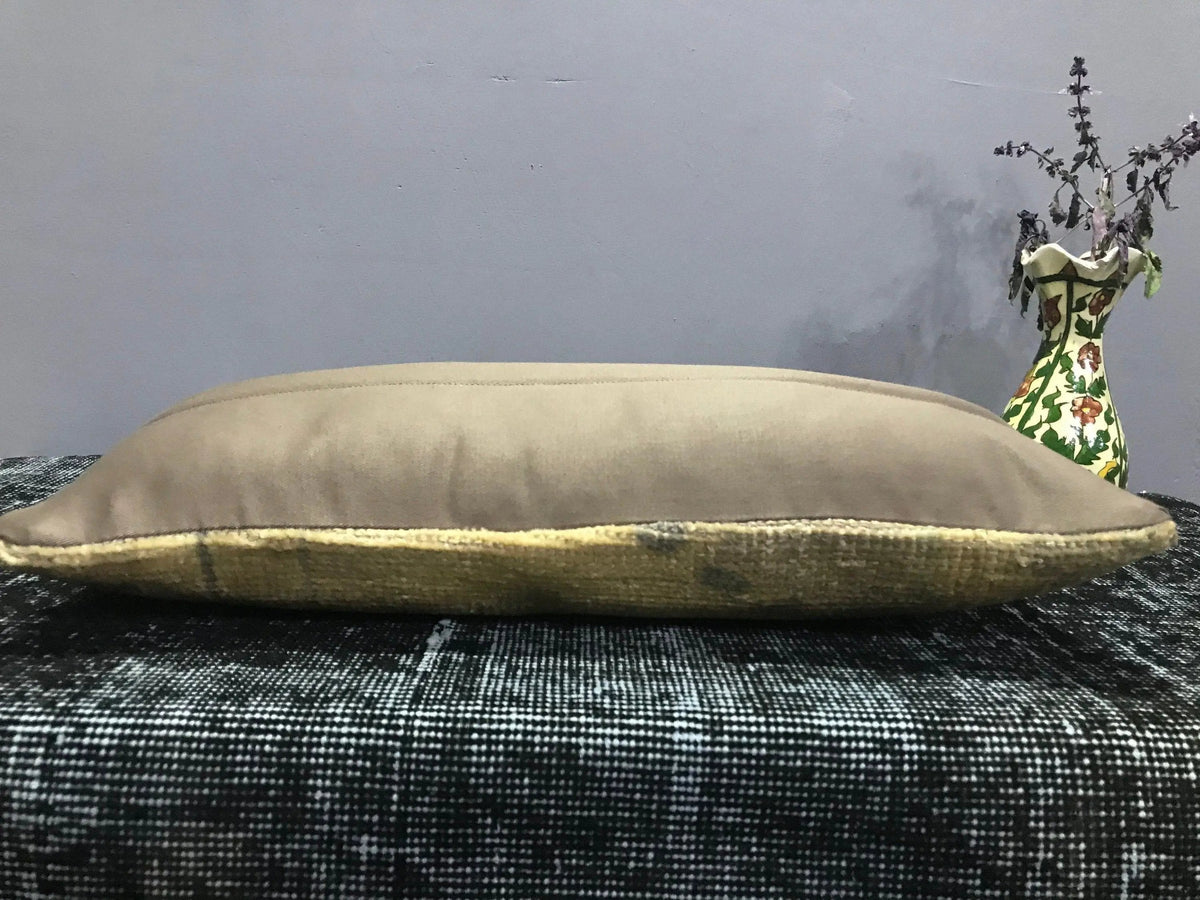 Beige Turkish throw pillow, shown on the floor.